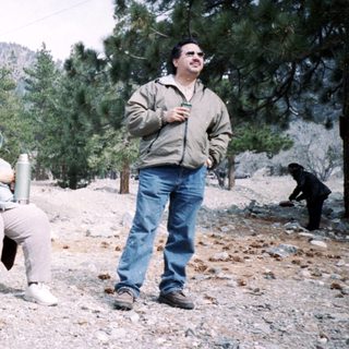 People camping outdoors in mountainous area.