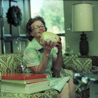 Woman drinking from a pineapple indoors.