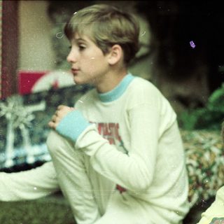 Two boys indoors holding mugs, possibly drinking.