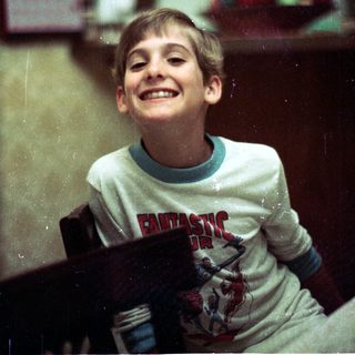 Happy young boy smiling indoors.