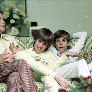 Family enjoying indoor gathering in cozy living room.