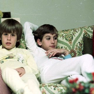Family enjoying time indoors together on a couch.