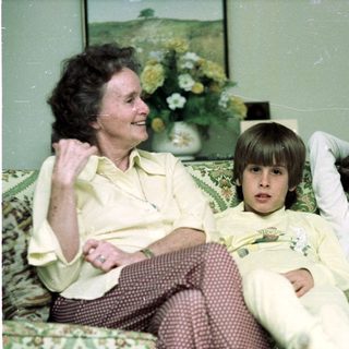 Family enjoying time indoors together on a couch.