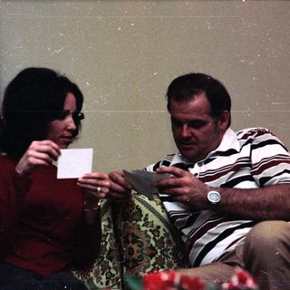 Two people playing card game indoors.