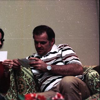 Two people playing card game indoors.