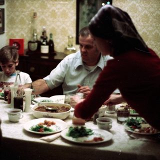 Family sharing meal together indoors.