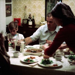 Family sharing meal together indoors.