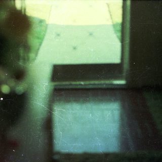 Blurred indoor view through a window.