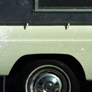 Vintage white delivery van with dark roof.