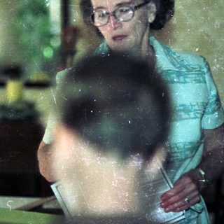 Vintage kitchen scene with woman and child.