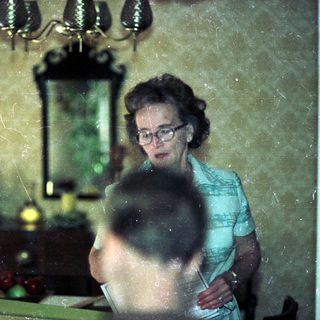 Vintage kitchen scene with woman and child.