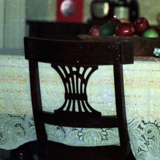 Child sitting at vintage table eating.
