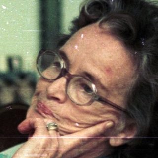 Woman resting thoughtfully in armchair at home.
