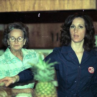 Two women in a pineapple processing facility.