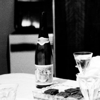 Woman sitting alone at table eating.