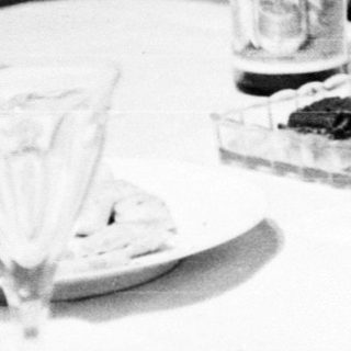 Woman sitting alone at table eating.
