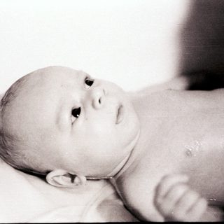Infant lying peacefully on back.
