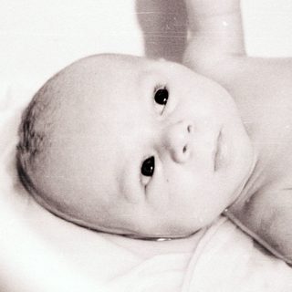 Baby lying in a bathtub.
