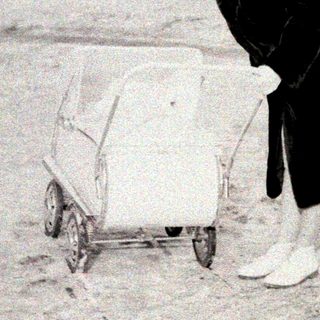 Person clearing snow from small vehicle in winter.