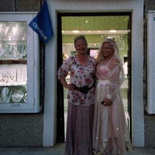 Two women posing outside a bakery named "Zlatna Pita."