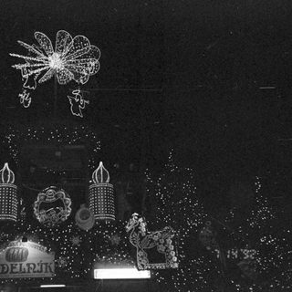 Fireworks display with illuminated dragon sculptures and clock.
