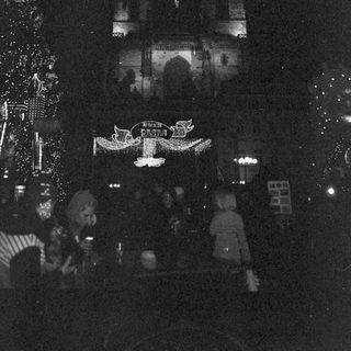 Illuminated holiday decorations at nighttime event.