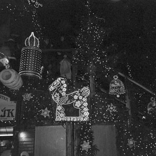 Illuminated holiday lanterns and horse decoration.
