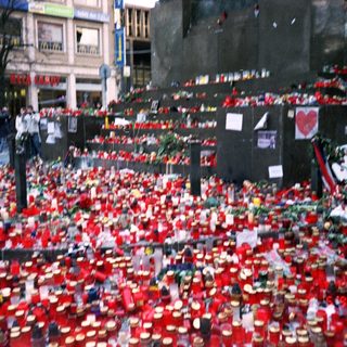Memorial tribute with red roses and candles.