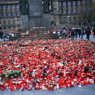 Memorial with numerous candles and flowers.
