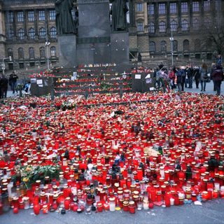 Memorial with numerous candles and flowers.