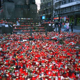 Memorial candles and flowers for victims.