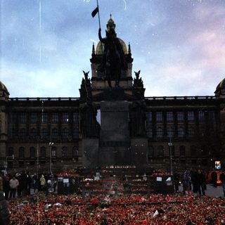 Memorial tribute with candles and flowers in Prague.