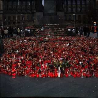 Memorial tribute with candles and flowers in Prague.