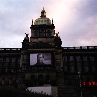 Grand building with large portrait projection.
