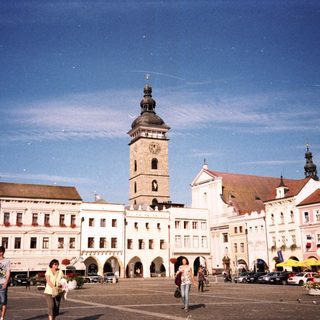 Historic European town square with clock tower.