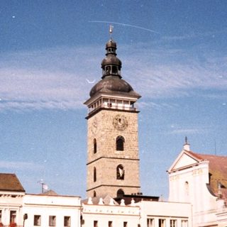 Historic European town square with clock tower.