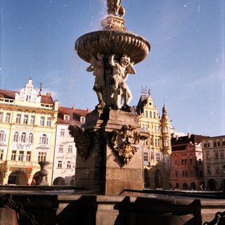 Baroque fountain with water spout in historic European square.