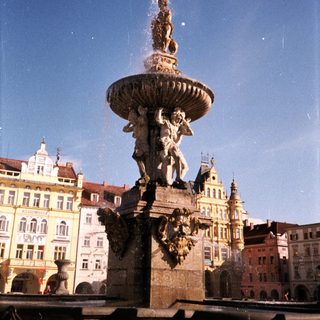 Baroque fountain with water spout in historic European square.