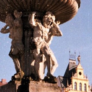 Baroque fountain with water spout in historic European square.