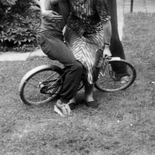 Family enjoying outdoor moment with bicycle.