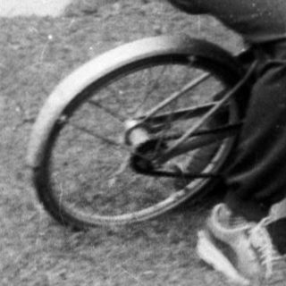 Family enjoying outdoor moment with bicycle.