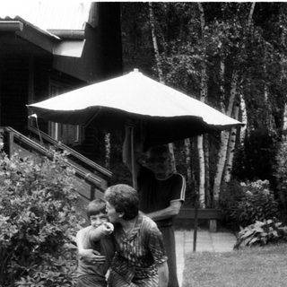 Family enjoying outdoor moment with bicycle.