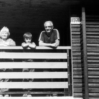 Family posing on a wooden porch.