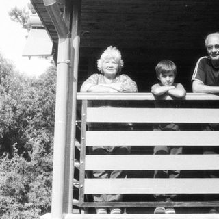 Family posing on a wooden porch.
