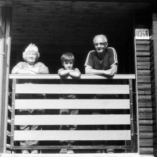 Family posing on a wooden porch.