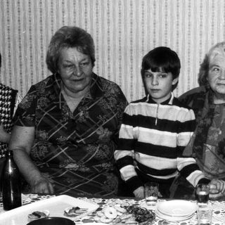 Family gathering indoors during a meal.