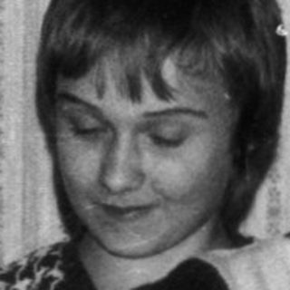 Two children playing board game indoors.