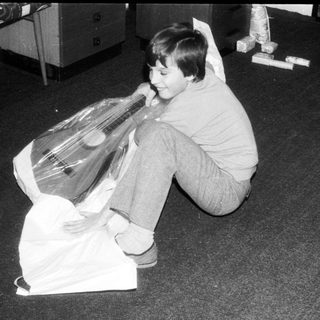 Child playing with large plastic bag.