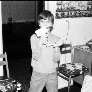 Young boy playing video game with handheld console.