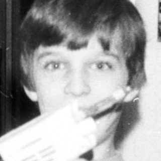 Young boy playing video game with handheld console.